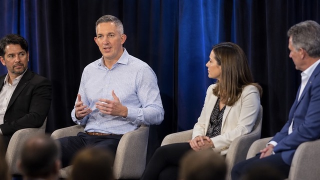 Kevin Miller discussing leadership on a panel with other speakers